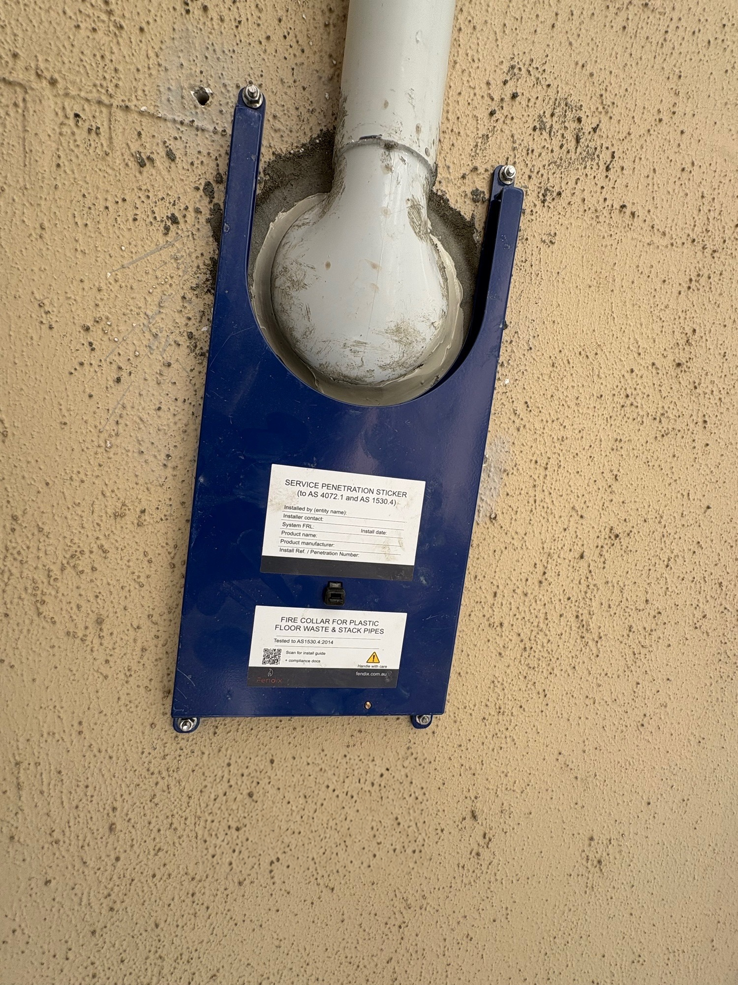 Fendix fire collar fitted around a Smart Trap beneath the concrete slab